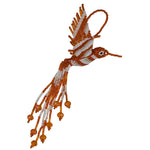 A handmade beaded hummingbird ornament featuring orange and white seed beads, with dangling bead strands and a hanging loop, shown on a plain white background.