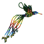 A colorful beaded hummingbird ornament with long trailing strands in rainbow colors and a hanging loop, photographed on a plain white background.