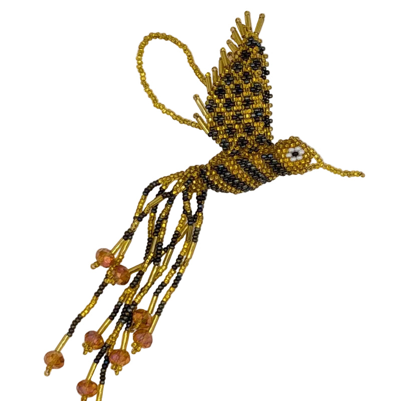A handmade beaded hummingbird ornament, featuring a gold and iridescent brown  body and wings, with dangling strands of gold and brown beads and gold crystal beads, set against a plain white background.