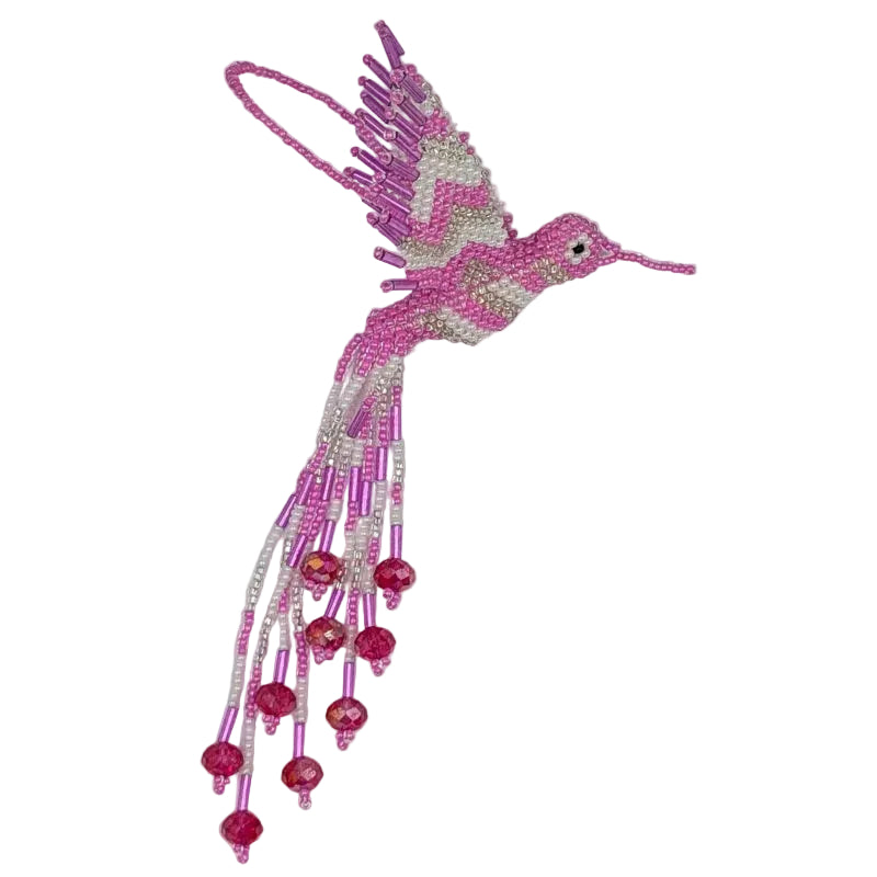 A pink and white beaded hummingbird ornament with zigzag design on the wings  and long dangling strands and faceted bead accents, photographed on a plain white background.