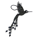 A beaded hummingbird ornament made from dark metallic gray glass seed beads, shown against a plain white background.