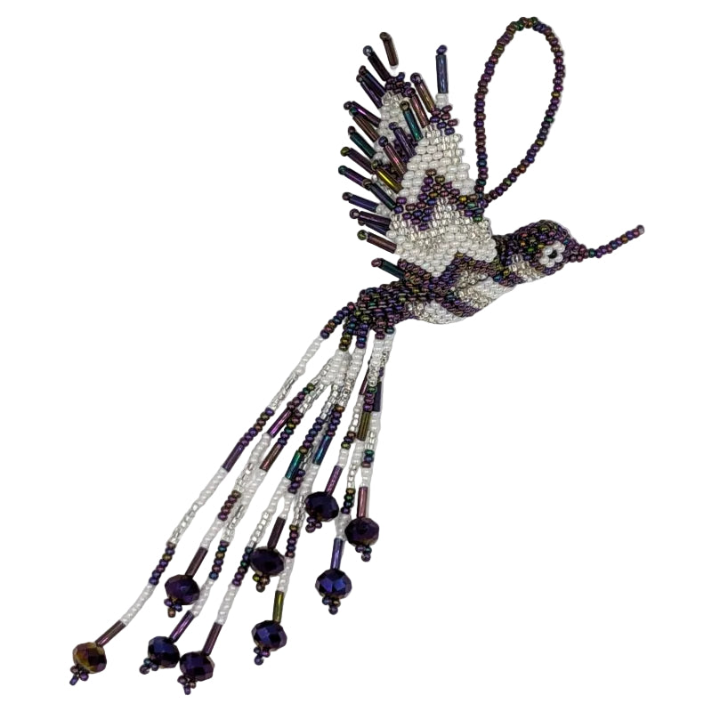 A handcrafted beaded hummingbird ornament, made from white and iridescent purple seed beads, photographed on a plain white background.